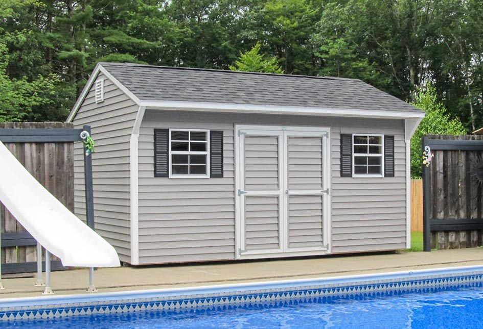 Gray Quaker Shed at a pool built by Adirondack Storage Barns