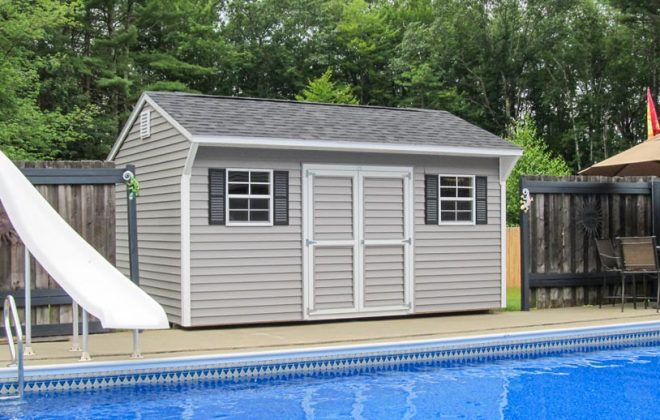 Gray Quaker Shed at a pool built by Adirondack Storage Barns