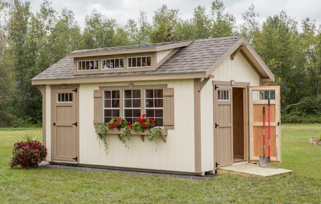 Doors open on a Navajo White Elite Dormer Shed built by Adirondack Storage Barns