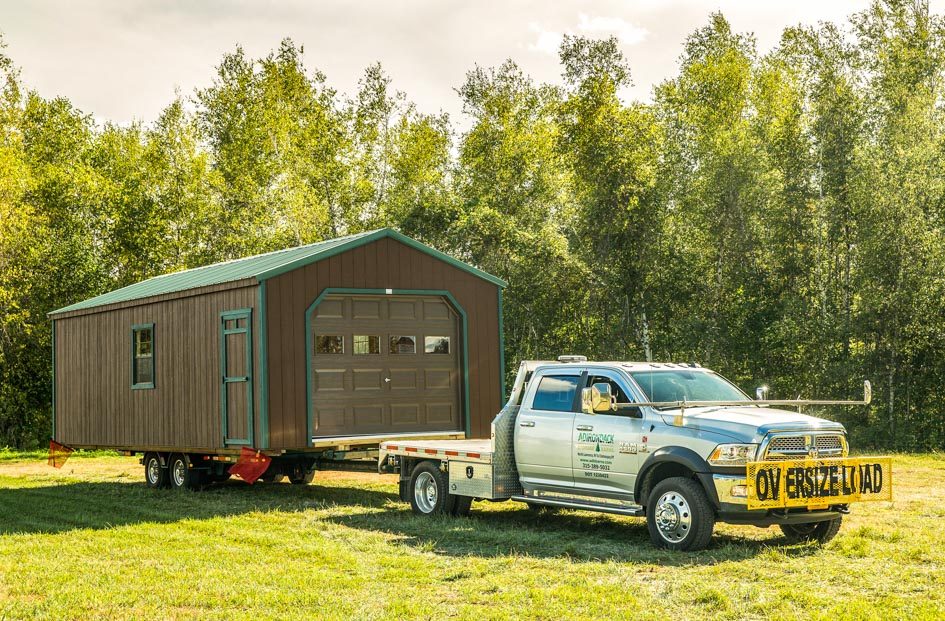 Delivery truck with a new shed on a trailer