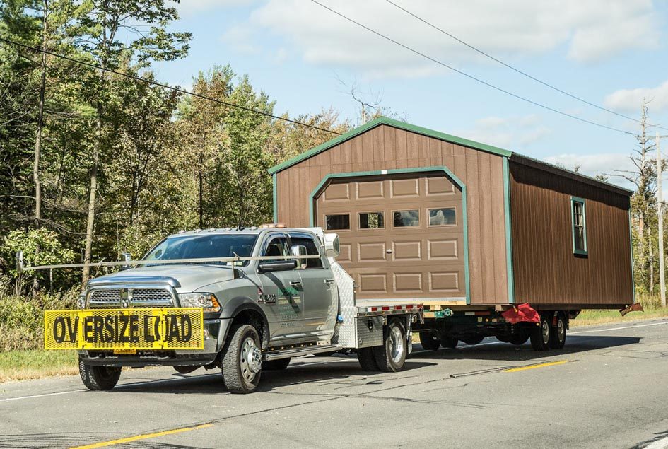 Delivery truck with a new shed on a trailer